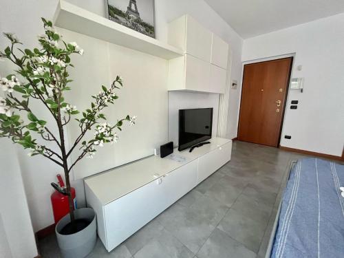 a living room with a tv on a white wall at Santa Giulia Terrace - 15 Mins City Center in Linate