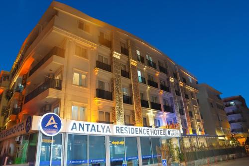 a large building with a sign in front of it at Antalya Residence Hotel in Antalya