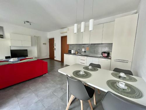 a kitchen and living room with a table and chairs at Santa Giulia Terrace - 15 Mins City Center in Linate