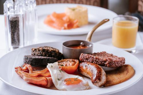 a plate of breakfast food with eggs sausage and toast at The Royal Hotel Campbeltown in Campbeltown