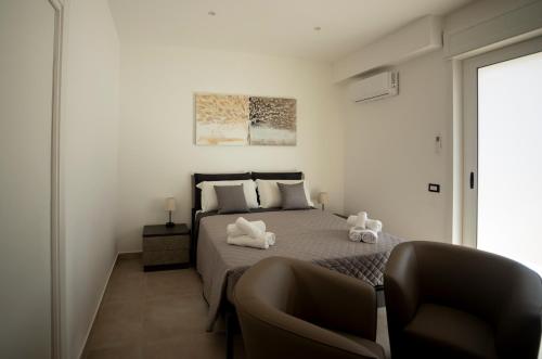 a bedroom with a bed with two stuffed animals on it at Umberto Home 303 in Catania