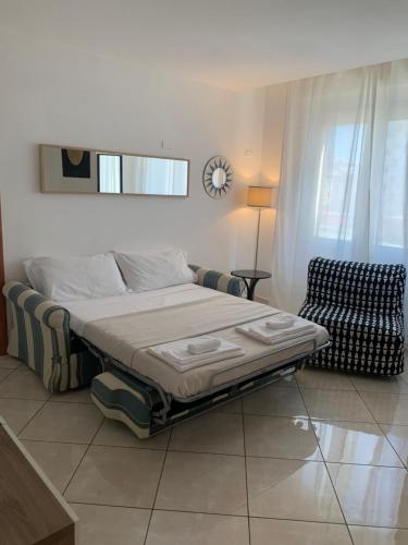 a bedroom with a bed and a chair in it at Tuanis in Naples