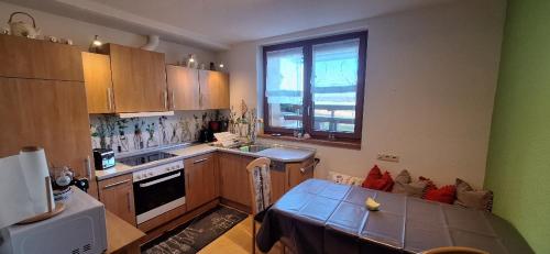 a kitchen with a table and a dining room at Haus Bührer in Freiamt