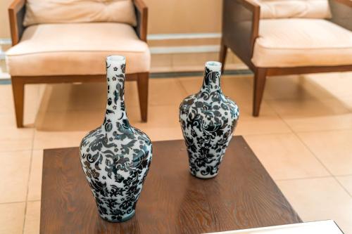 two black and white vases sitting on a table at Hotel Nacional Inn Guarujá in Guarujá