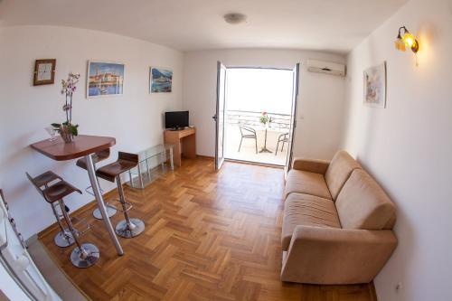 a living room with a couch and a table at Apartments Charme in Bečići