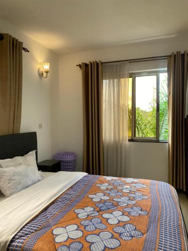 a bedroom with a bed with a colorful blanket on it at One Bedrooms 230 Heron Drive Nyari Estate in Nairobi