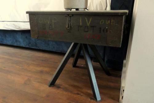 an old chest sitting on a table next to a bed at Watertoren Hengelo in Hengelo