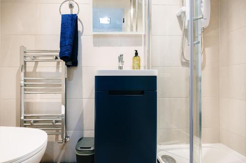a bathroom with a sink and a toilet at Harlington 3-Bed House by Brookland Stays Short Lets with Wi-Fi in Harmondsworth