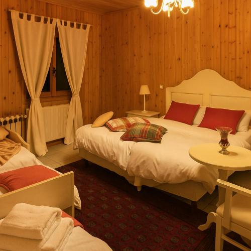 a bedroom with two beds and a chandelier at Aithra Boutique Hotel in Tsivlós