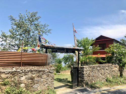 ナガルコットにあるHotel Mountain Nestの石垣前看板建て建物