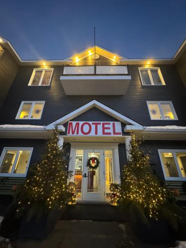 a hotel with christmas trees in front of it at Horizon 777 in Saint-Siméon