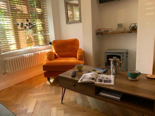 a living room with a chair and a coffee table at Minster Cottage - Cathedral Quarter with Free Parking in Lincoln