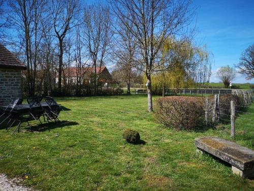 a park with a bench and a table in the grass at Les Lavandins Château de Musigny in Musigny