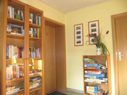 a room with two book shelves filled with books at Ferienhof Bohg in Burg