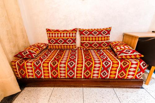 a bed in a room with two pillows at Riad Les Champs De Fès in Fès