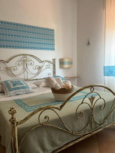 a bedroom with a bed with a basket on it at ASSUMBRA Casa Vacanze in Santa Maria Navarrese