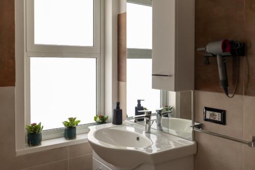 a bathroom with a sink and a window at Umberto Home 303 in Catania