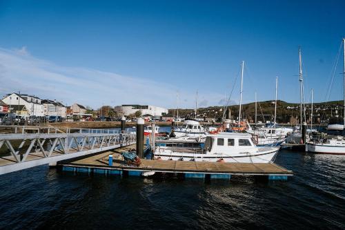 a group of boats docked at a dock in the water at The Royal Hotel Campbeltown in Campbeltown