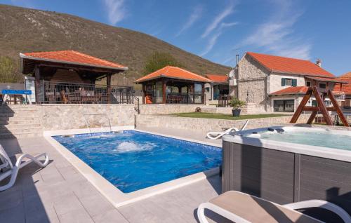 a swimming pool in a yard with a house at Villa Ivandvor in Sinj