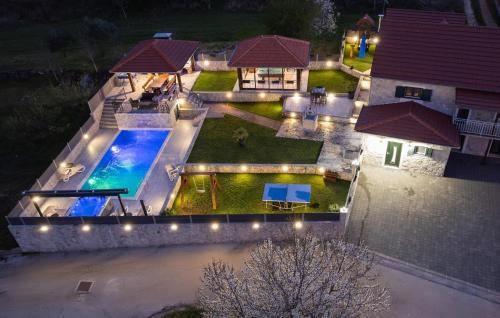 an aerial view of a house with a swimming pool at night at Villa Ivandvor in Sinj