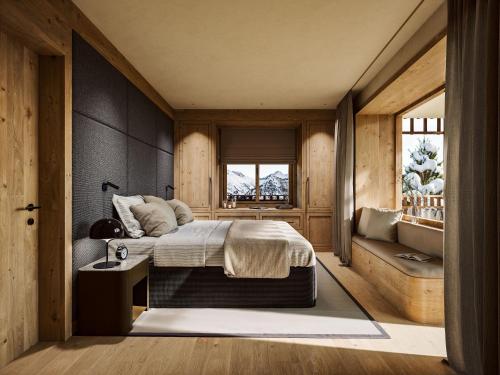 a bedroom with a bed and a window at Sandhof Apartments in Lech am Arlberg