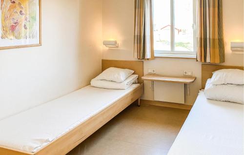 a small room with two beds and a window at 2 Bedroom Nice Home In Hok in Hok