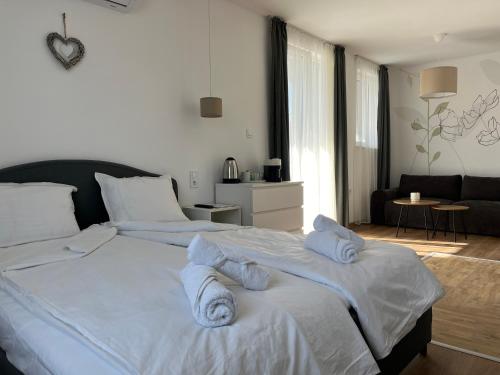 a bedroom with two beds with towels on them at Villa YoSi in Sapareva Banya