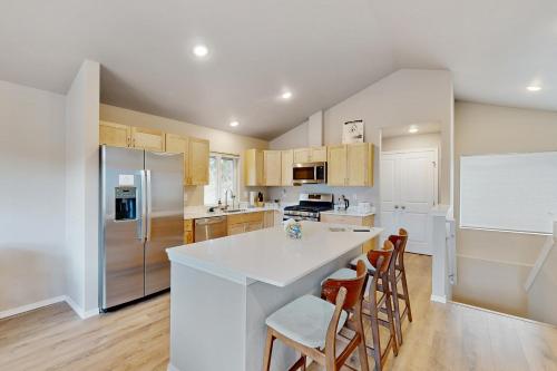 a kitchen with a white counter top and wooden cabinets at Girdwood Vibes, Unit B in Girdwood