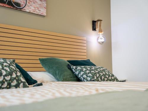 a bedroom with a bed with pillows on it at el apartamento de la playa in Santander