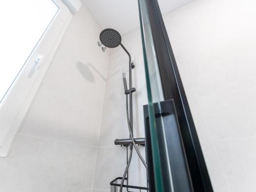 a shower in the corner of a bathroom at el apartamento de la playa in Santander