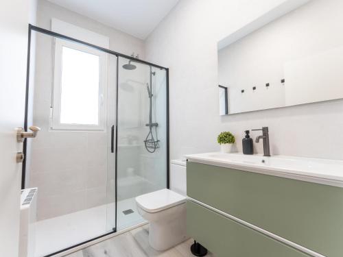 a bathroom with a shower and a toilet and a sink at el apartamento de la playa in Santander