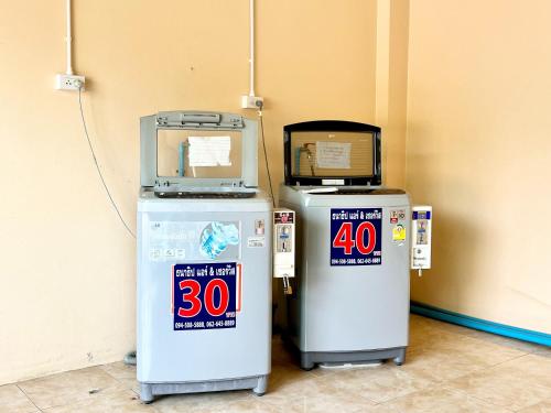 two machines are sitting next to a wall at Sunshine Place Udon in Udon