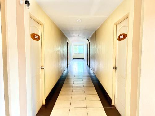 a hallway with two doors and a hallwayngth at Sunshine Place Udon in Udon