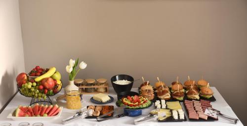a table with sandwiches and other food on it at The Oscar Olympic Hotel in Thessaloniki