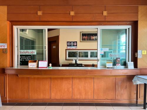 a restaurant with a counter with signs on it at Sunshine Place Udon in Udon