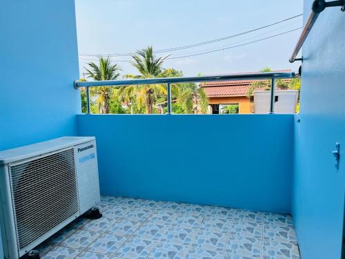 a room with a blue wall and a heater at Sunshine Place Udon in Udon