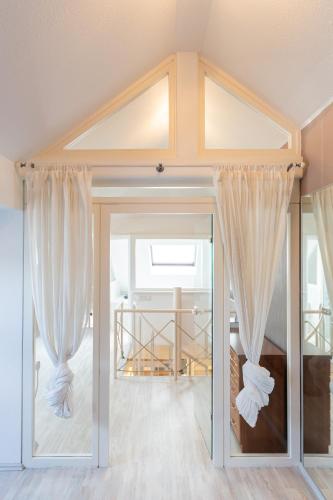 a room with sliding glass doors with curtains at Macabu Premium Apartment Joker,Chemnitz in Chemnitz