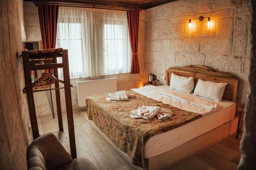 a bedroom with a bed with towels on it at Cappadocia Snora Cave in Nevsehir