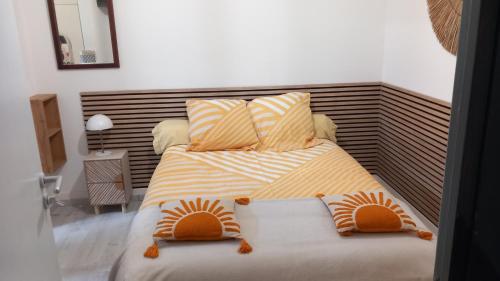 a bedroom with a bed with two pillows at Studio Robine les halles avec clim in Narbonne