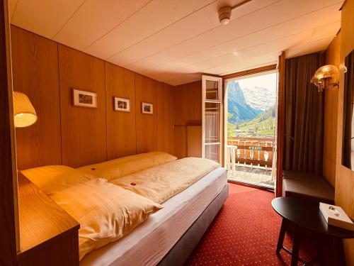 Postel nebo postele na pokoji v ubytování Hotel Staubbach