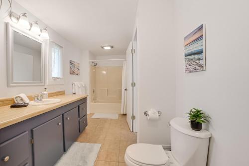 a bathroom with a toilet and a sink at Close to 3 Ski Areas Michigan Family Retreat! in Charlevoix