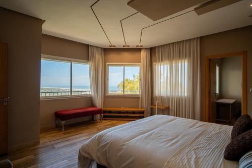 a bedroom with a bed and a large window at Best 4 Bedroom Luxury Villa In Mediouna in Jbila