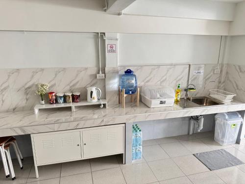 a kitchen with a sink and a counter top at Daisy house pattaya in Jomtien Beach