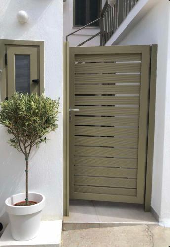 a garage door with a plant in front of it at Olive green house in Skiathos
