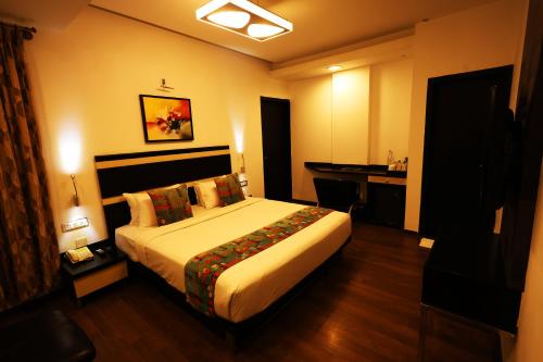 a hotel room with a bed and a desk at Purple Brigade, Bangalore in Bengaluru