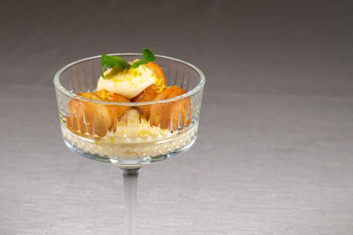 a dessert in a wine glass on a table at Hotel Villa Rita in Paestum