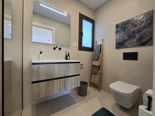 a bathroom with a sink and a toilet at Chalet del Faro in Cabo de Palos
