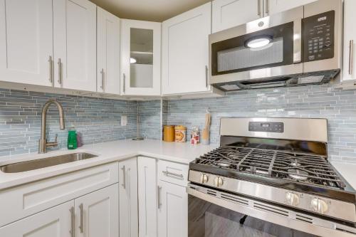 a kitchen with white cabinets and a stove top oven at Walk to Beach and Dtwn Apt in Ocean Grove in Ocean Grove