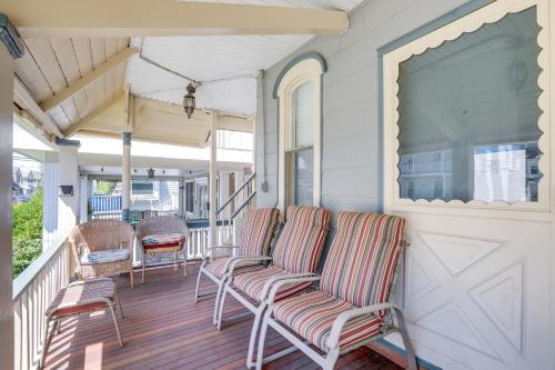 a porch with two chairs and a sliding door at Walk to Beach and Dtwn Apt in Ocean Grove in Ocean Grove