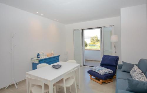 a living room with a blue couch and a table at Lovely Apartment In Marina Di Modica in Marina di Modica